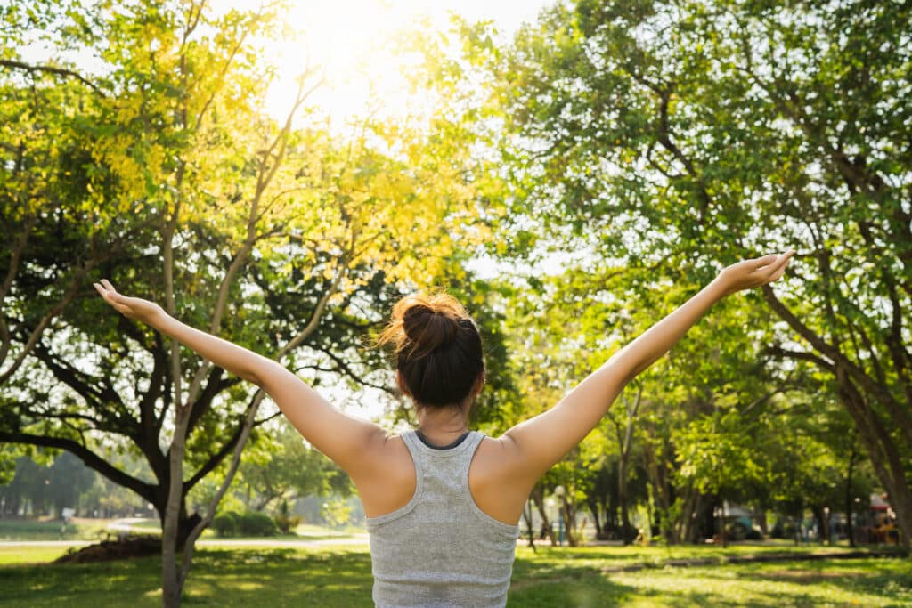 woman exercising outdoors in the sun feeling good