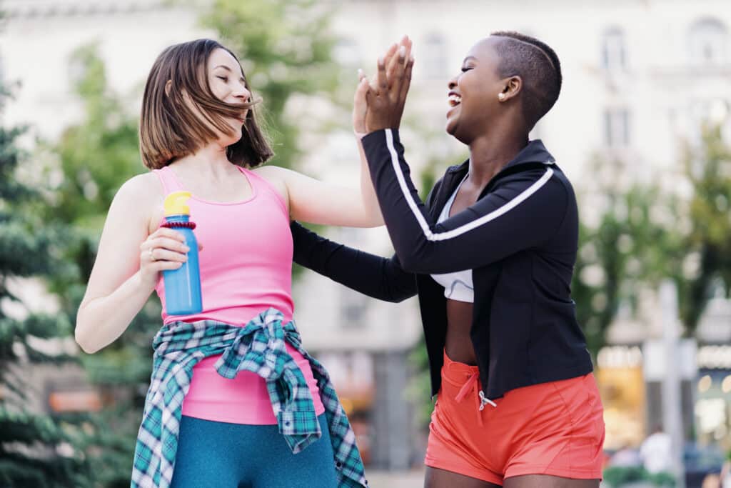 two women celebrating after a workout exercise